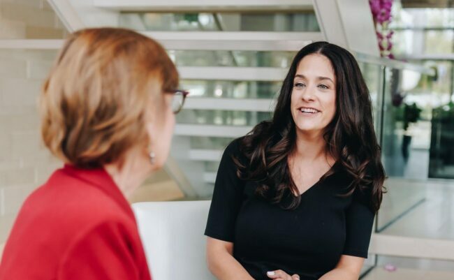 Two women sitting and talking portrait