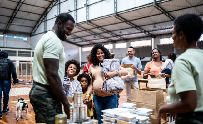 Refugee family getting a donation in a sheltering
