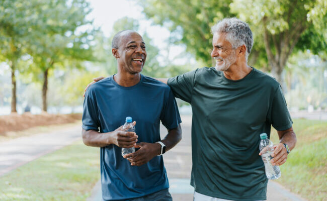 Senior friends walking in public park