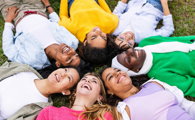 Diverse happy women bonding together at city park.
